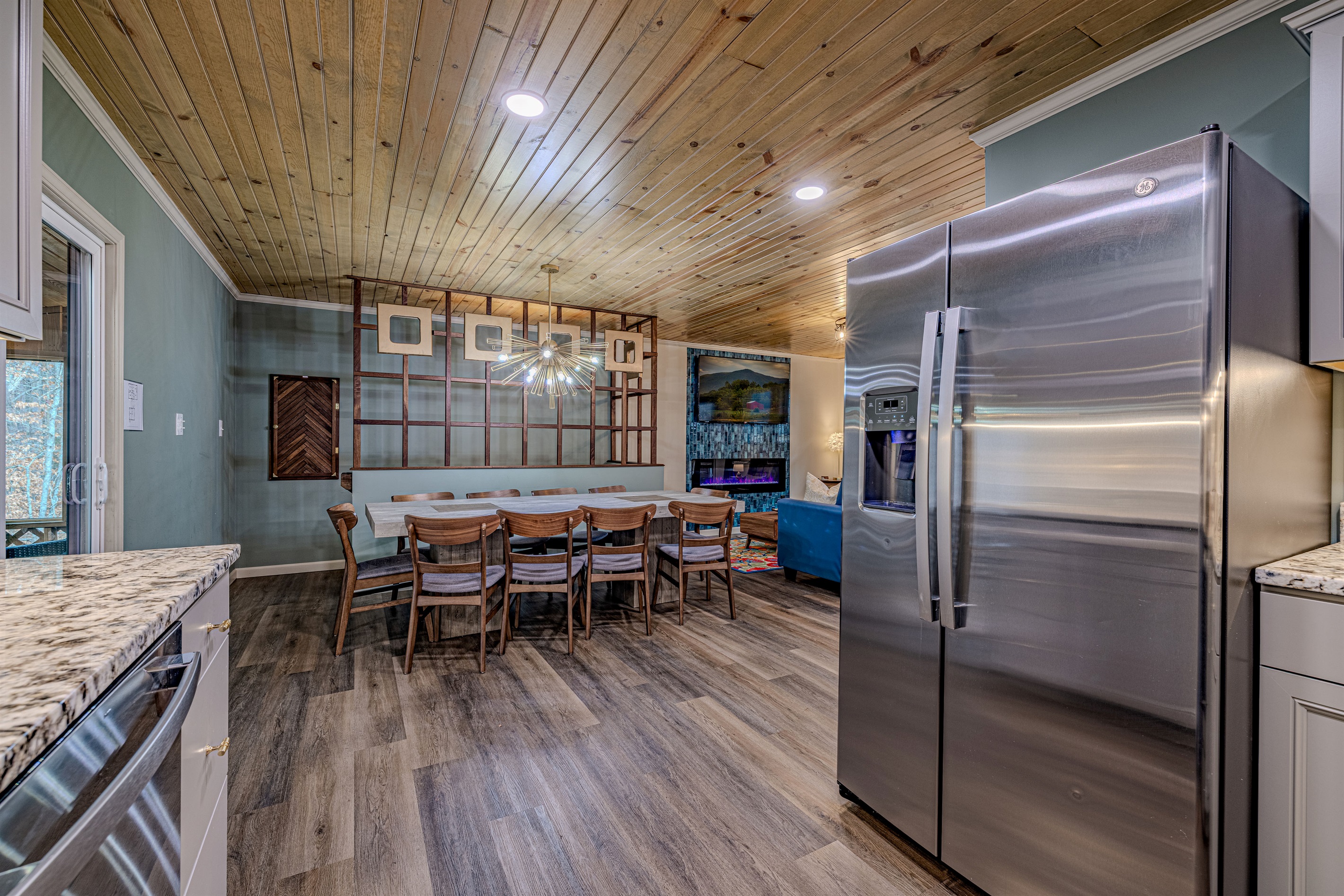 Mid-Century Modern masterpiece! The striking Sputnik chandelier and the beautiful wood-slat room divider make this space shine.