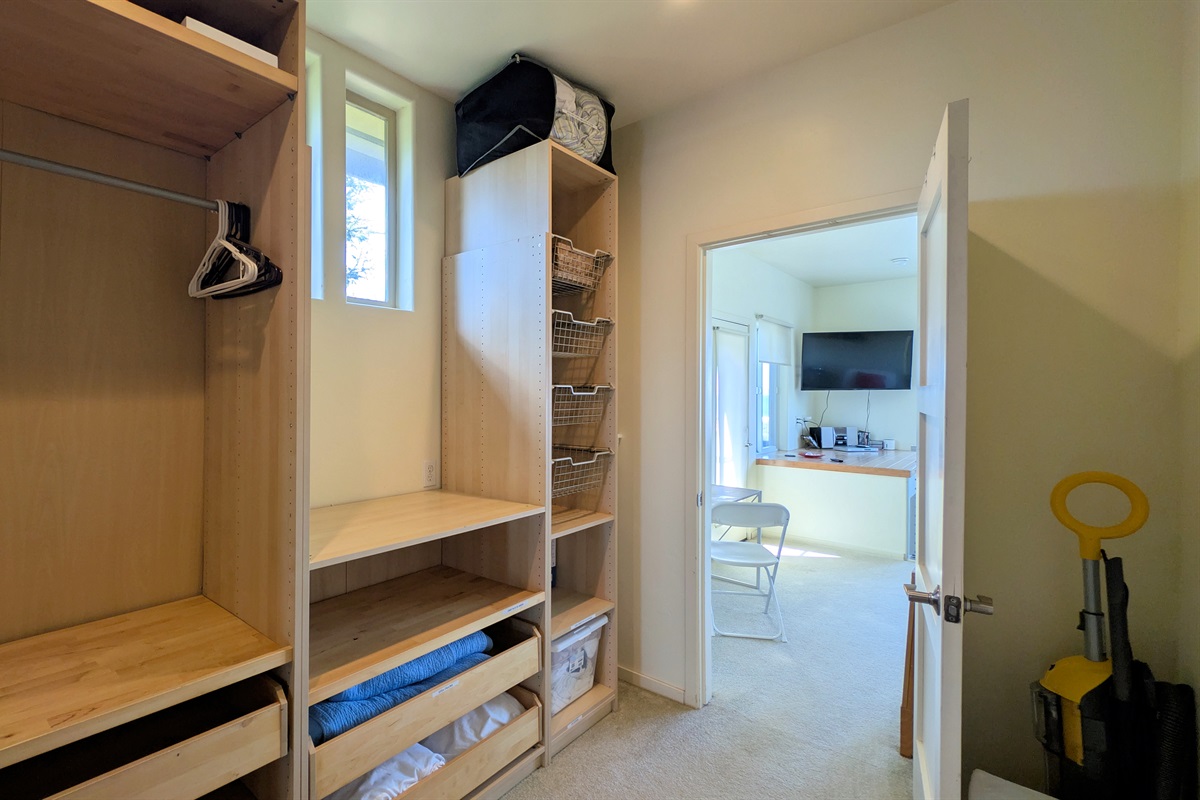walk in closet in primary bedroom, a place for your suitcases and hanging clothes.