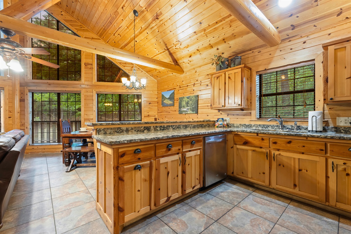 Bright kitchen with forest views and cabin warmth.