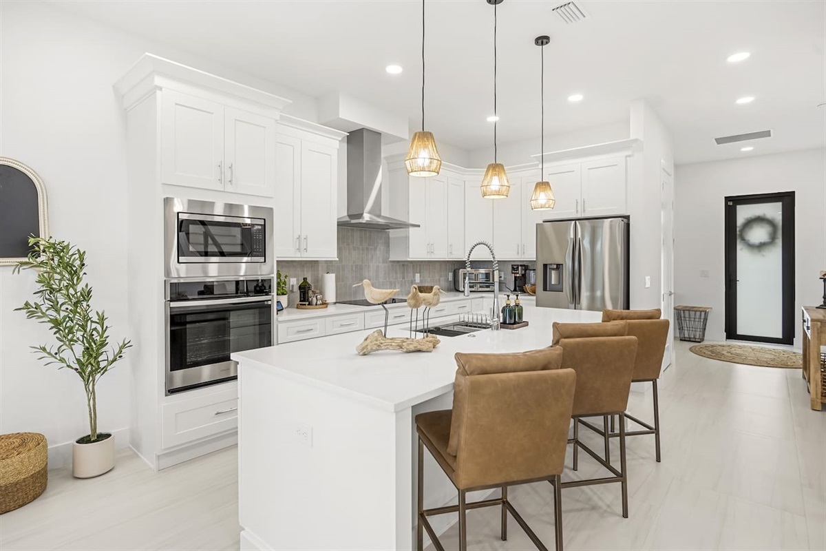 Our brand-new luxury kitchen features a spacious island, perfect for cooking meals or enjoying a casual drink, with high-end finishes and modern appliances throughout.