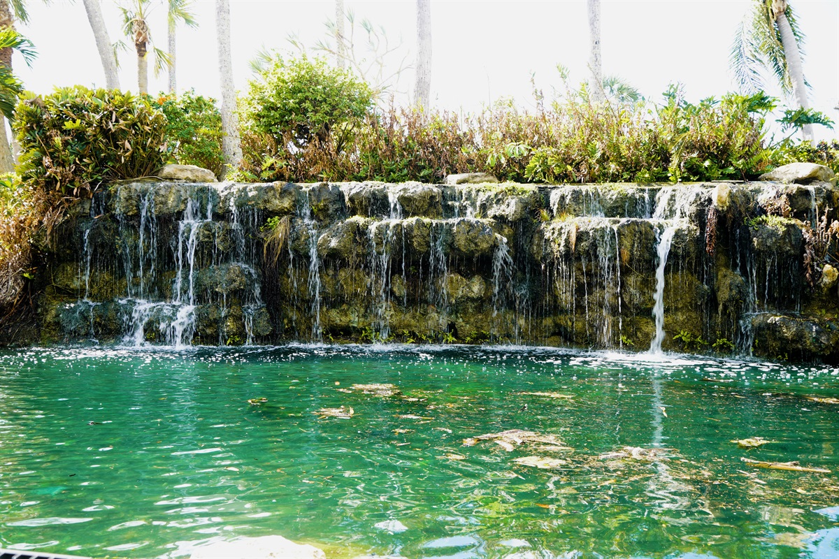 Tranquil waterfall feature brings peaceful vibes to your vacation backdrop.