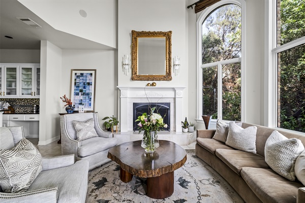 Formal sitting room on the main floor, right off the kitchen and dining area with access to the patio. Enjoy the morning sunrise overlooking downtown.