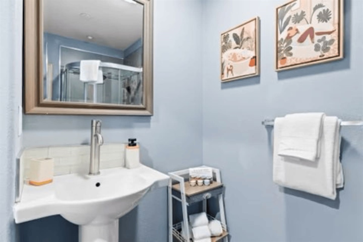 Convenient full bath stocked with body soap, shampoo, fresh towels, and essentials for guests.