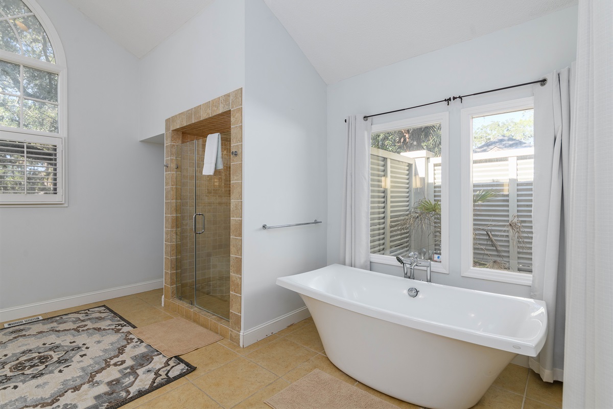 Deep soaking tub overlooking private deck