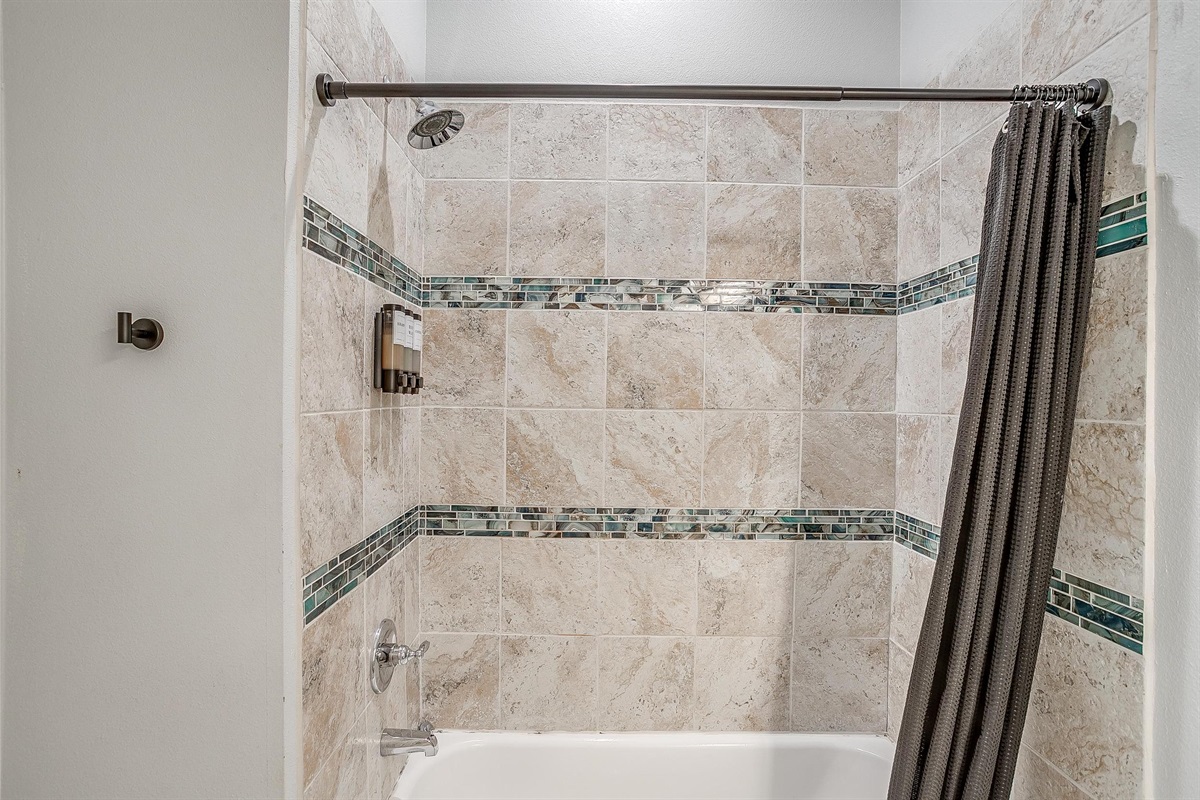 Bright walk-in shower with clean tile and fresh vibe.