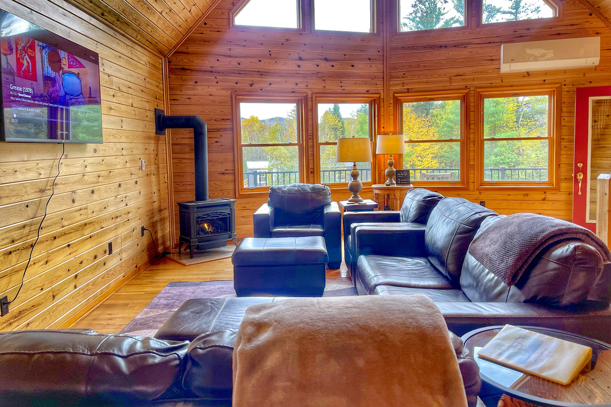 Enjoy cozy evenings in our bright, inviting living room, featuring abundant natural light, a gas stove, and a 60-inch Smart TV.
