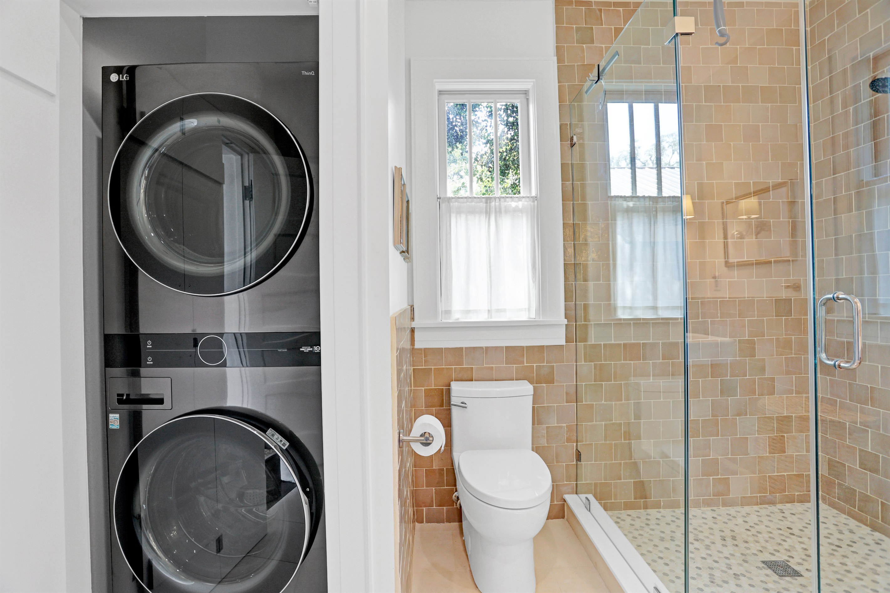 The discreet washer and dryer tucked in the bathroom make laundry easy during your extended stay.