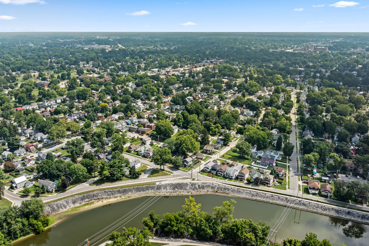 Tree-lined streets and a scenic river bend show just how walkable this neighborhood is.