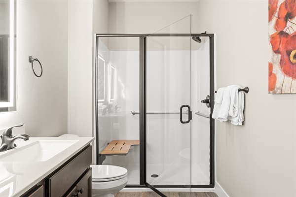 Master Bathroom #2 features a walk-in shower with a low step entry and a fold-down seat to accommodate guests with accessibility needs.