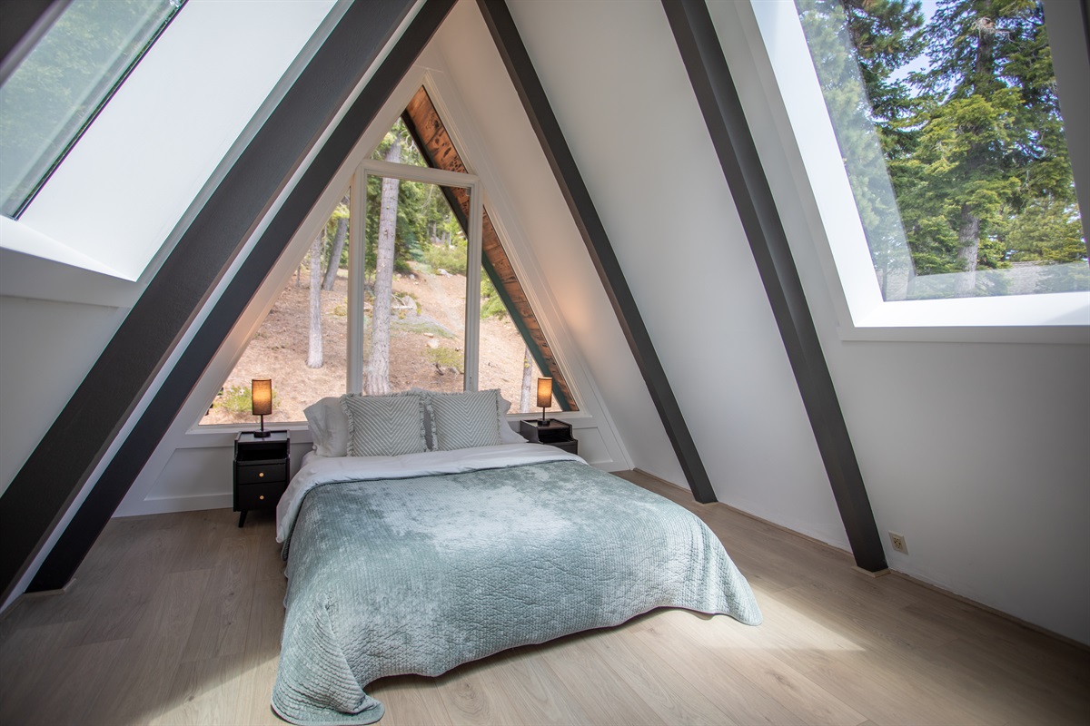 Second bedroom has views of the forest and lake.