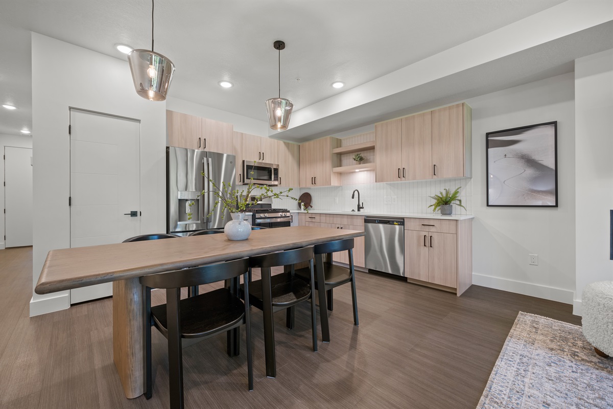 This well equipped kitchen features a gas stove, fridge with ice maker, microwave, and modern appliances.