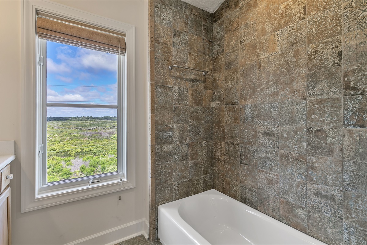 Large upstairs shared tub/shower combo bathroom with views of Guana  Preserve