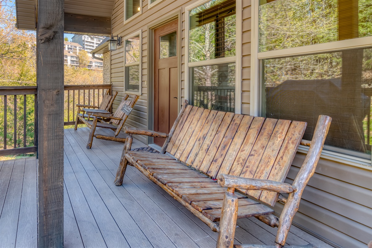 Front porch entry with rustic wood furniture