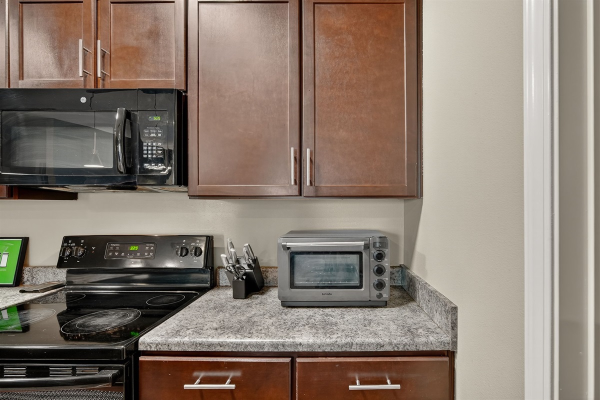Extra countertop appliances and well-stocked essentials for convenient home-cooked meals.