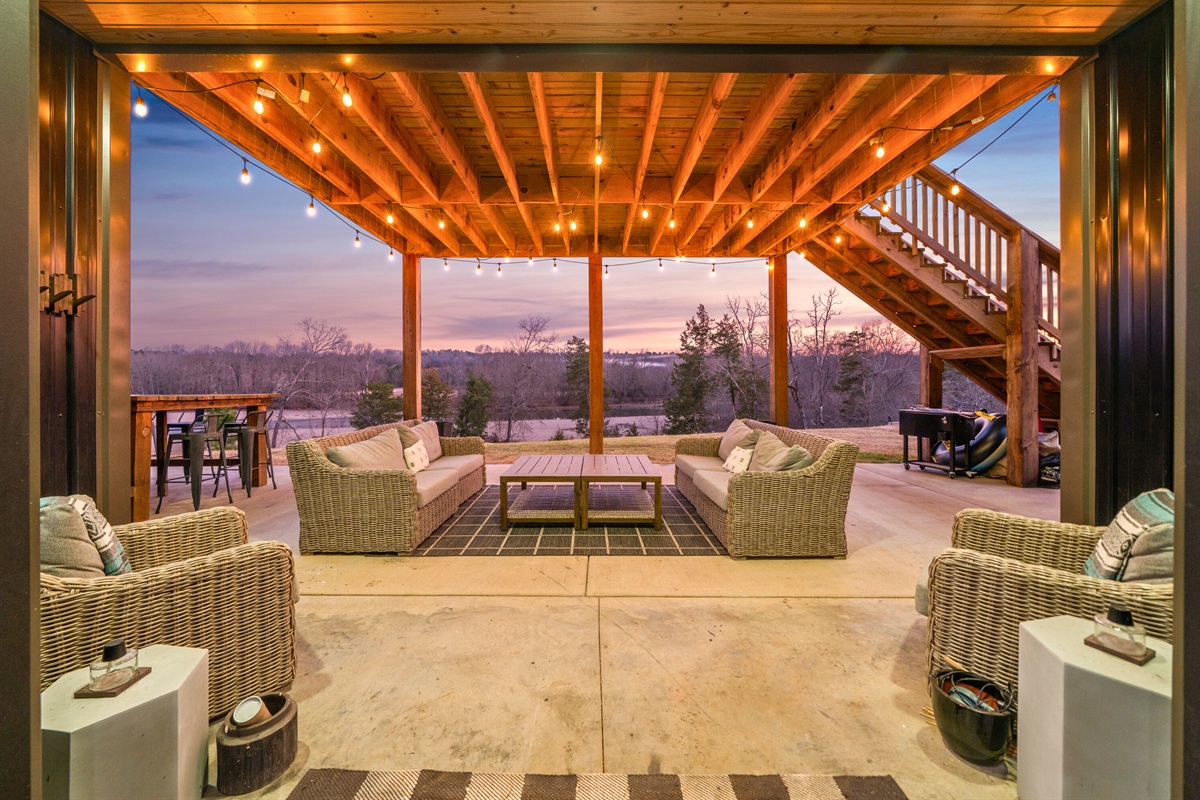 As evening sets in, the covered patio glows with warm lighting, creating a cozy atmosphere for gathering outdoors.