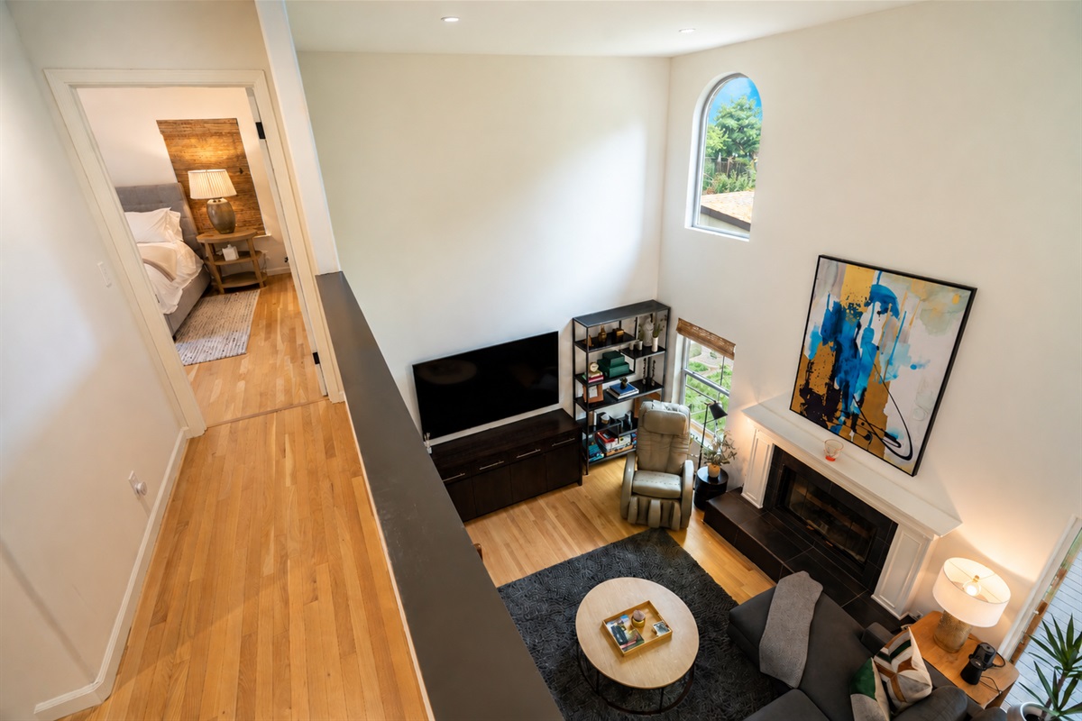 Living area with smart tv, massage chair and fireplace.