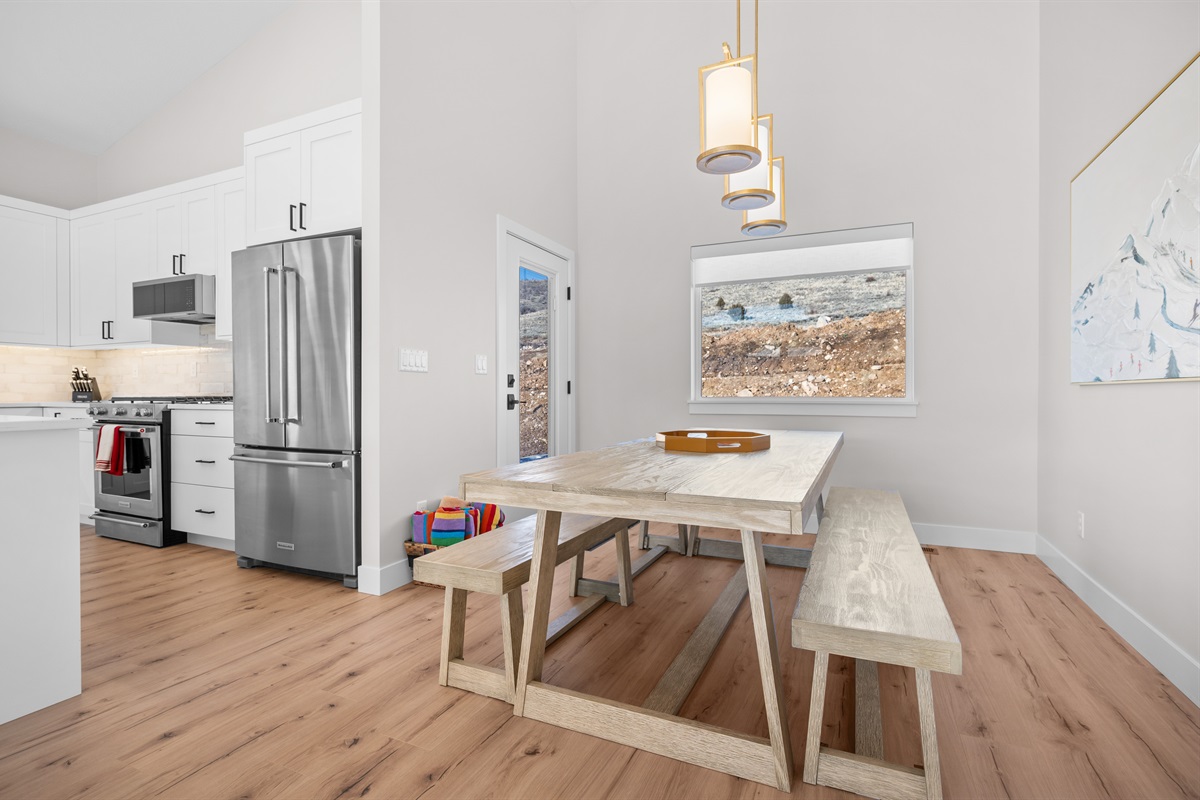 Bright dining space with mountain views and warm pendant lighting.