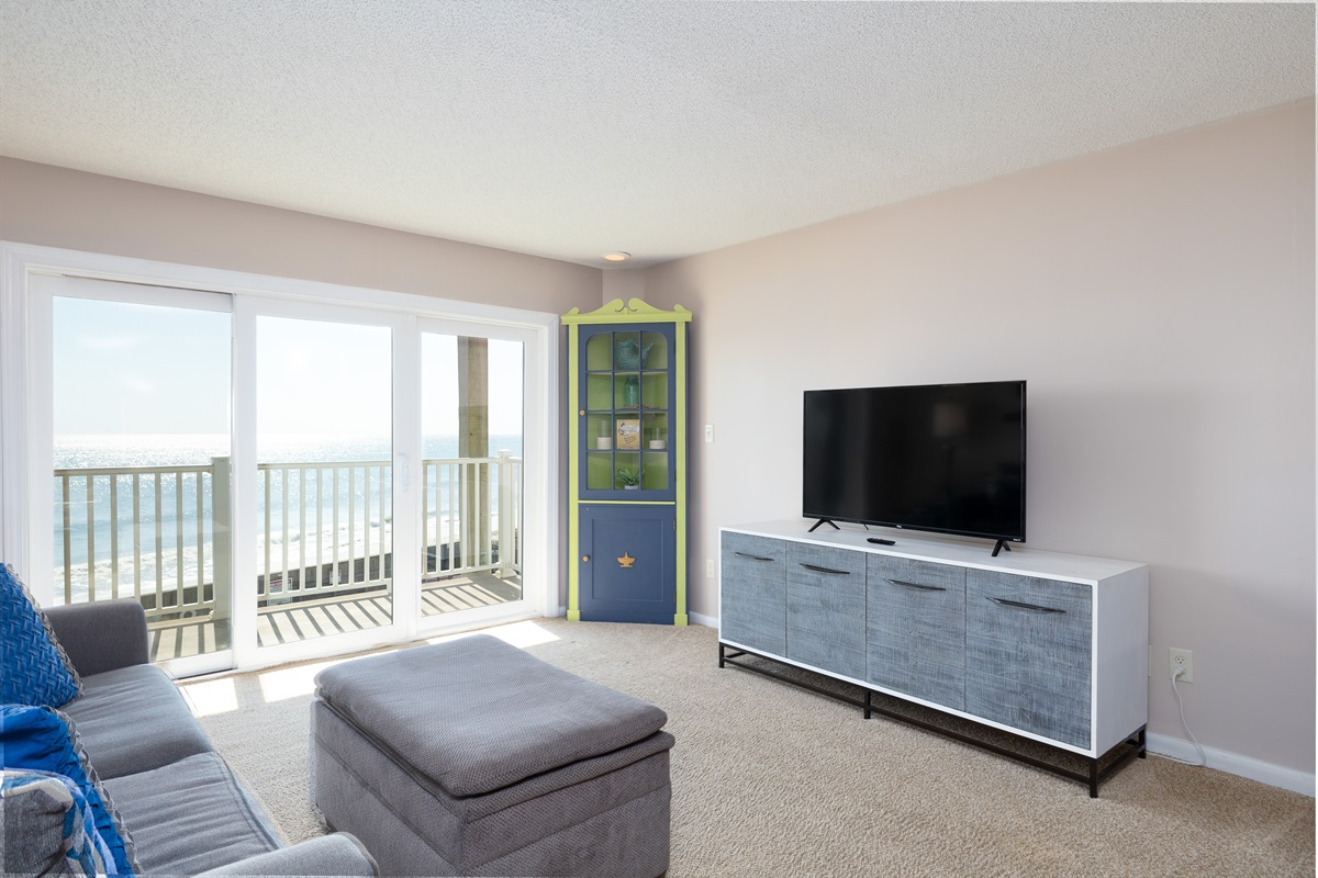 A TV for entertainment and a balcony with stunning ocean views