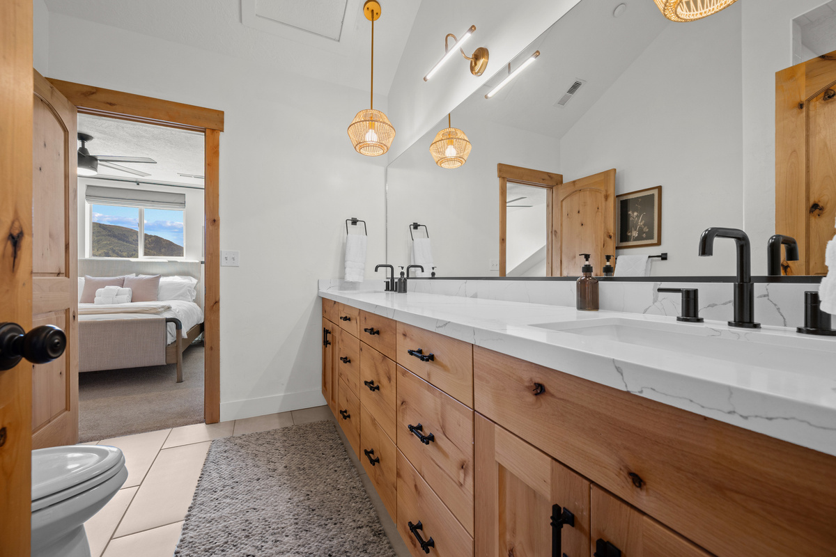 The shared Jack-and-Jill bathroom offers stylish finishes and convenient access between bedrooms.