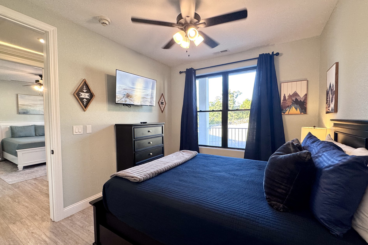 Bedroom 2 has a queen bed with Roku TV, two nightstands, lamps, dresser, closet, all bed linens, extra pillows, blanket, extra set of sheets, and an alarm clock.