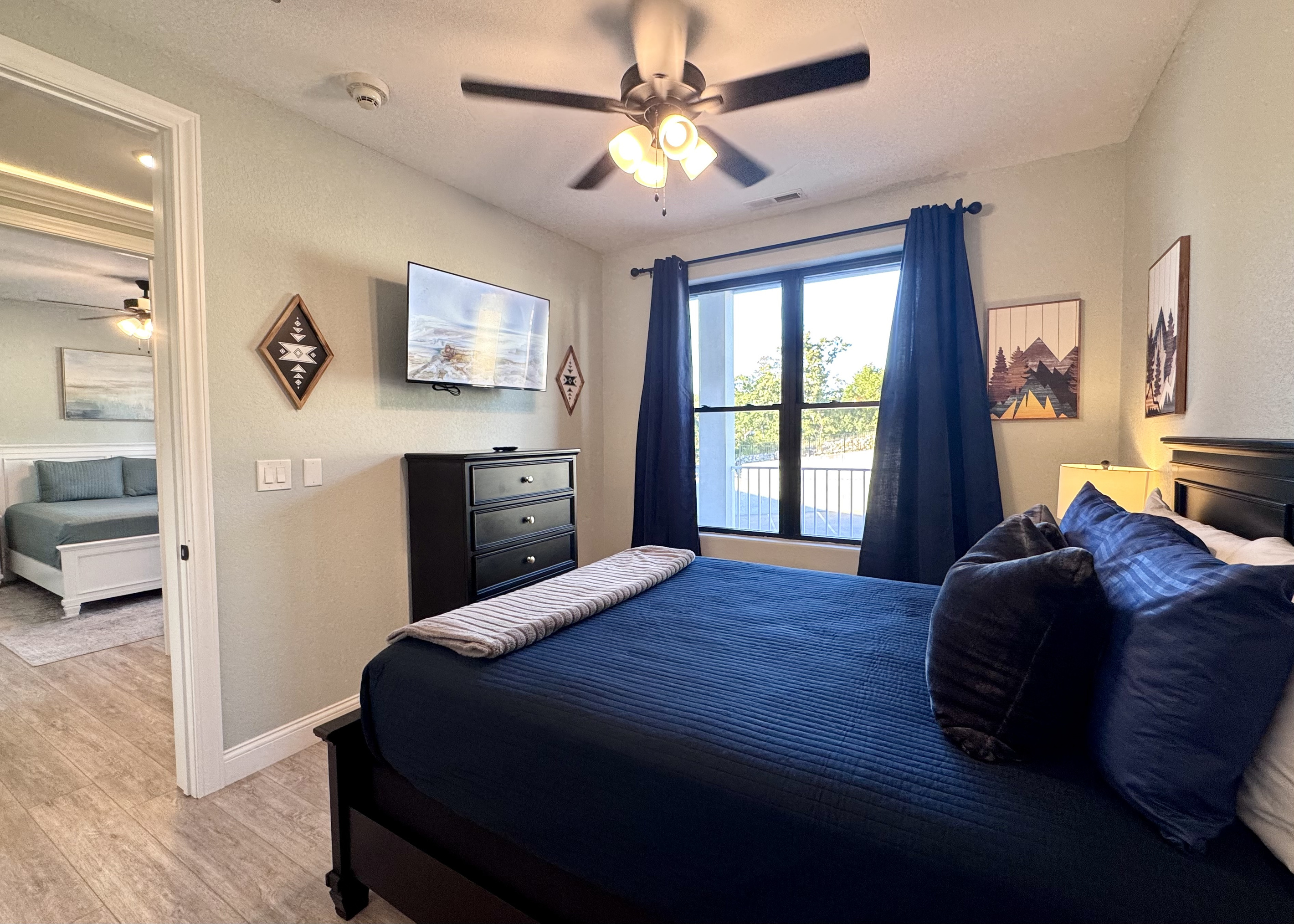 Bedroom 2 has a queen bed with Roku TV, two nightstands, lamps, dresser, closet, all bed linens, extra pillows, blanket, extra set of sheets, and an alarm clock.