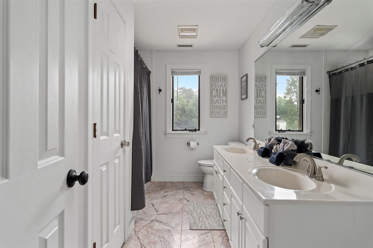 Full Bathroom 3: Bright, stylish retreat with double sinks and serene views for ultimate relaxation!