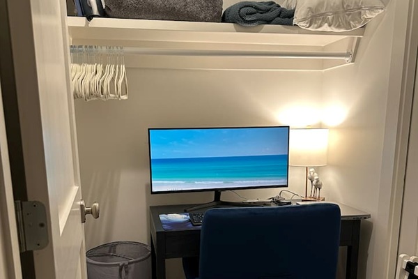 Dedicated Workspace - Tucked off the first-floor king suite, this private workspace features a small window, door, desk, comfortable chair, large monitor, docking station, keyboard, and a mouse—ideal for remote work while enjoying your beach getaway.