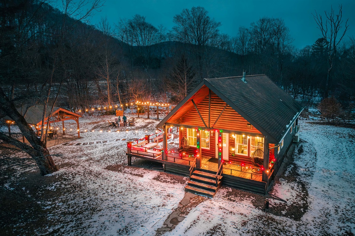 Your private winter retreat—glowing cabin lights, fire pit nights, and total seclusion under the stars.