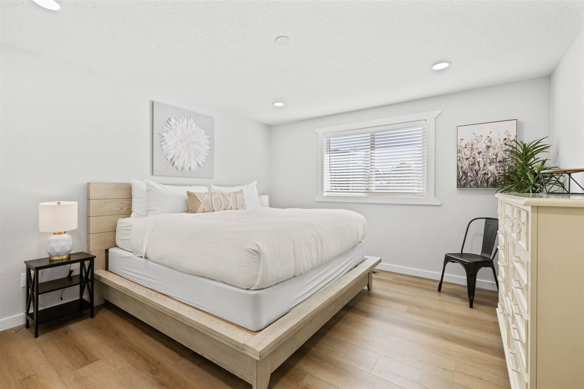 Primary Bedroom features King Bed and fill sized dresser and chair 