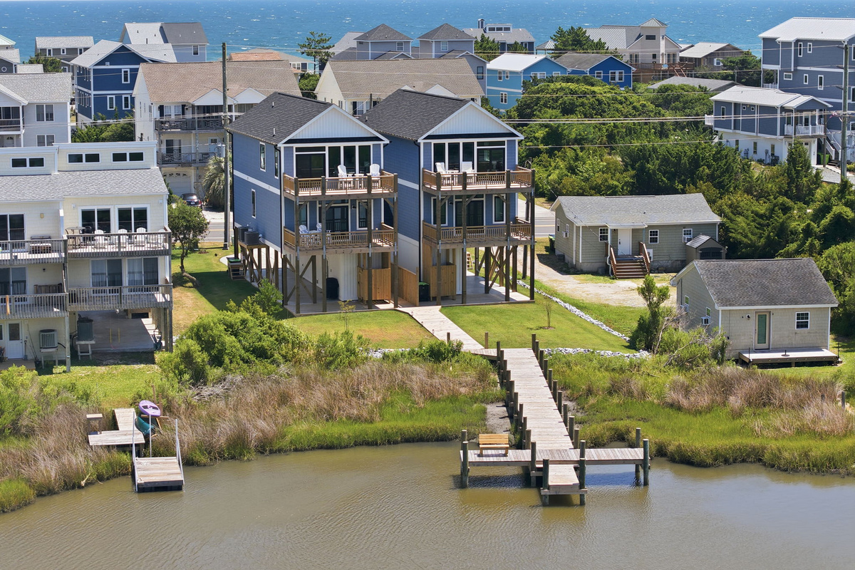 Take in sweeping aerial views of the marsh, surrounding neighborhood, and the Atlantic Ocean just beyond the homes