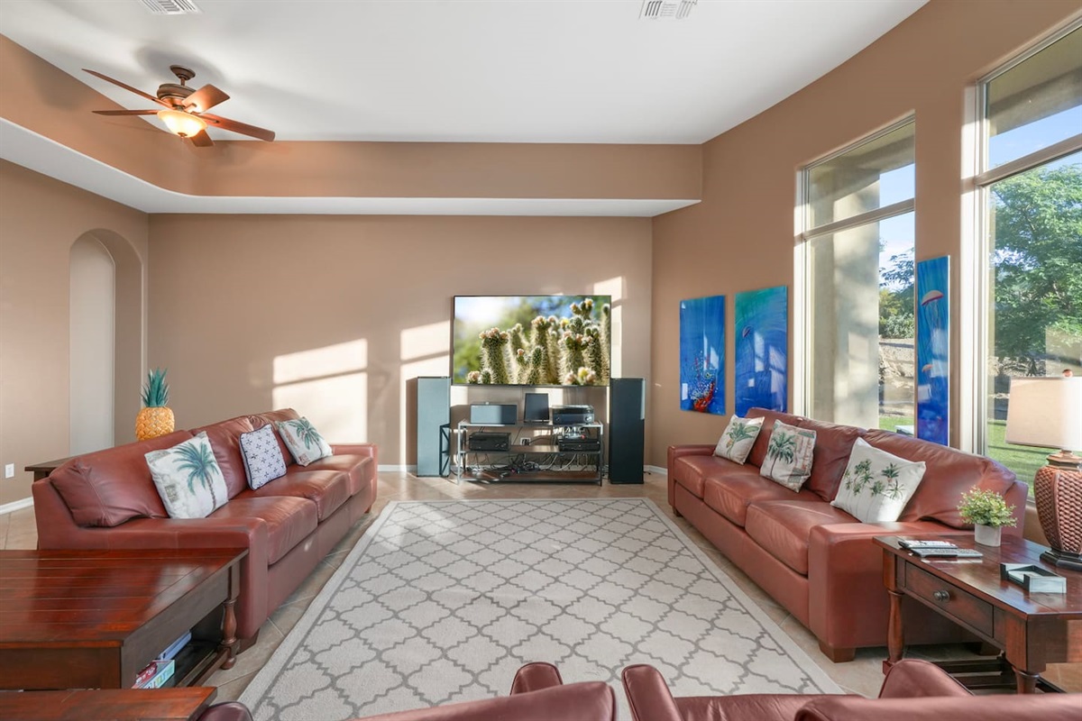Bright and airy living room with plush leather sofas and modern desert décor
