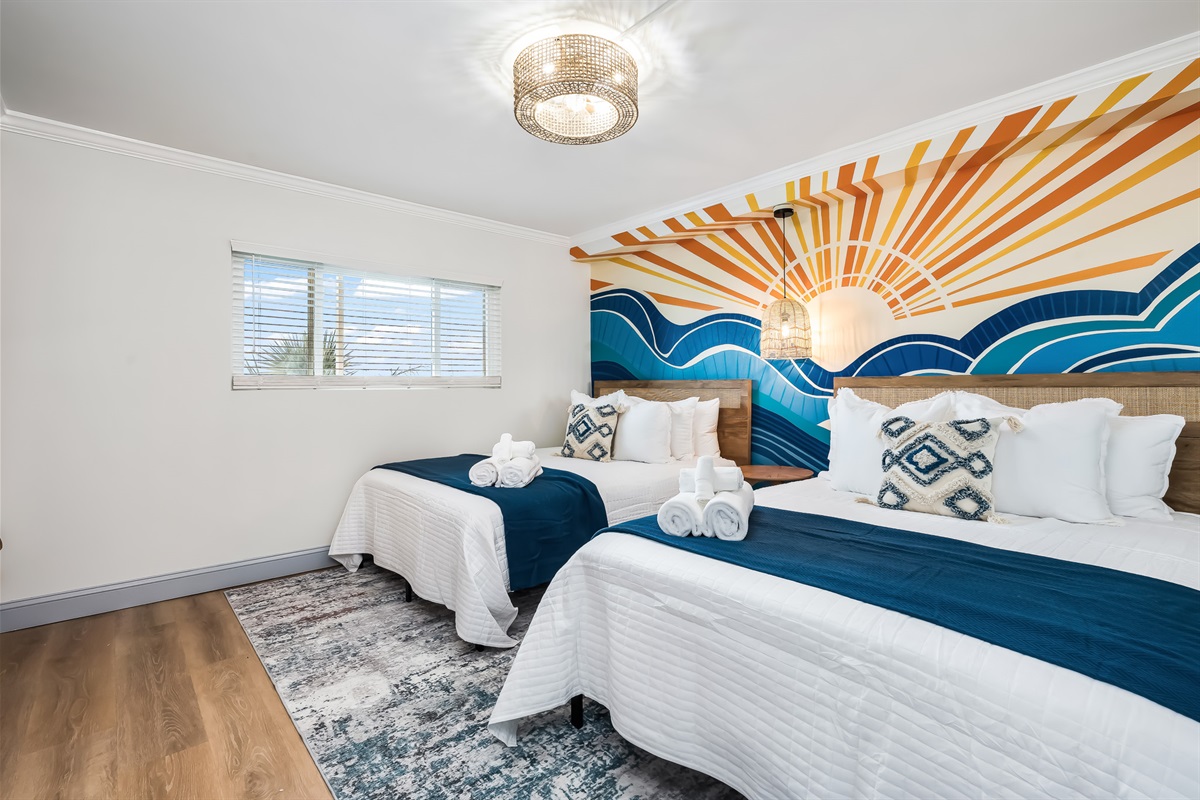Sunshine spills across the beds, adding warmth to this cheerful retreat.