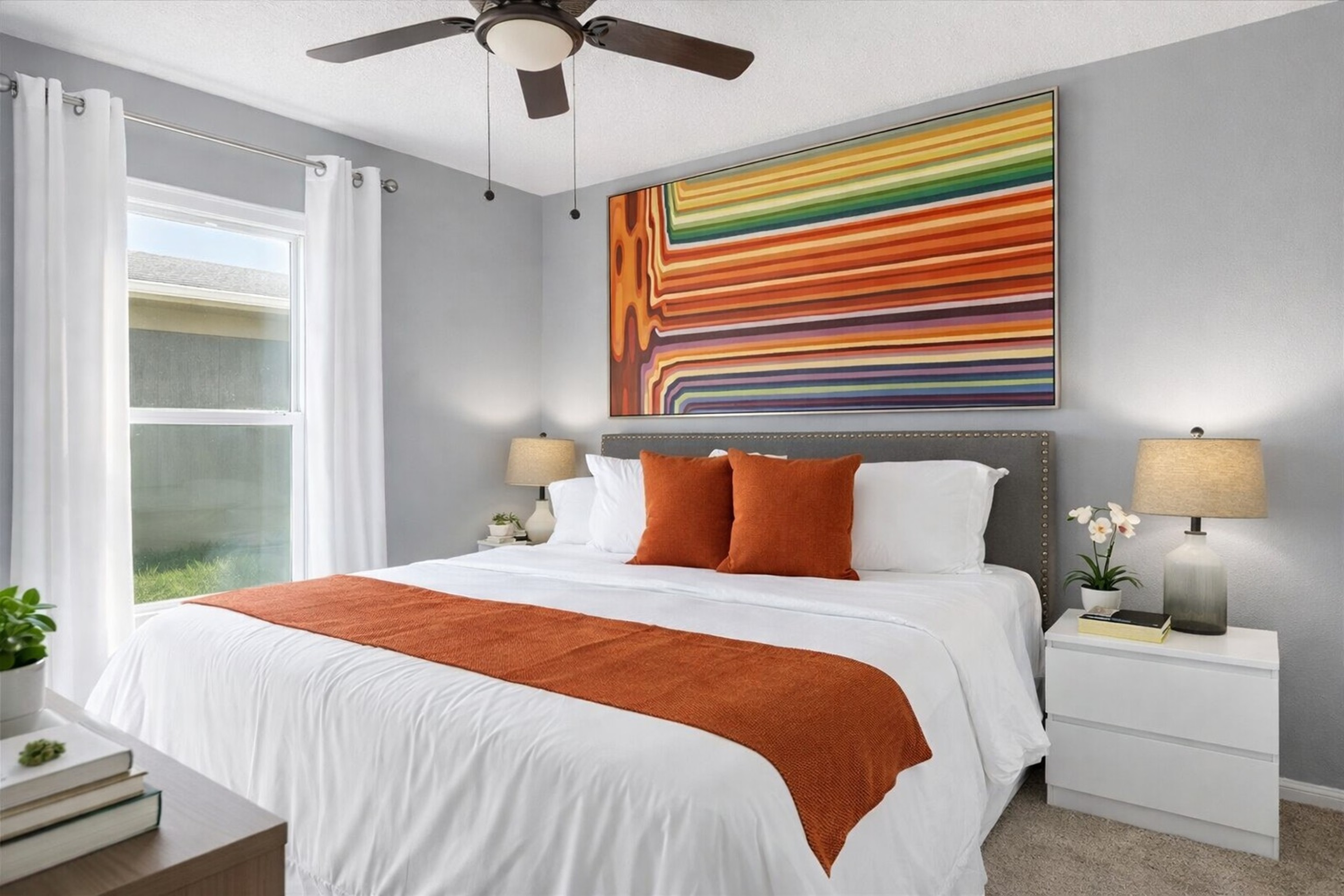 Modern KING bedroom with a large colorful abstract painting and natural light from the window