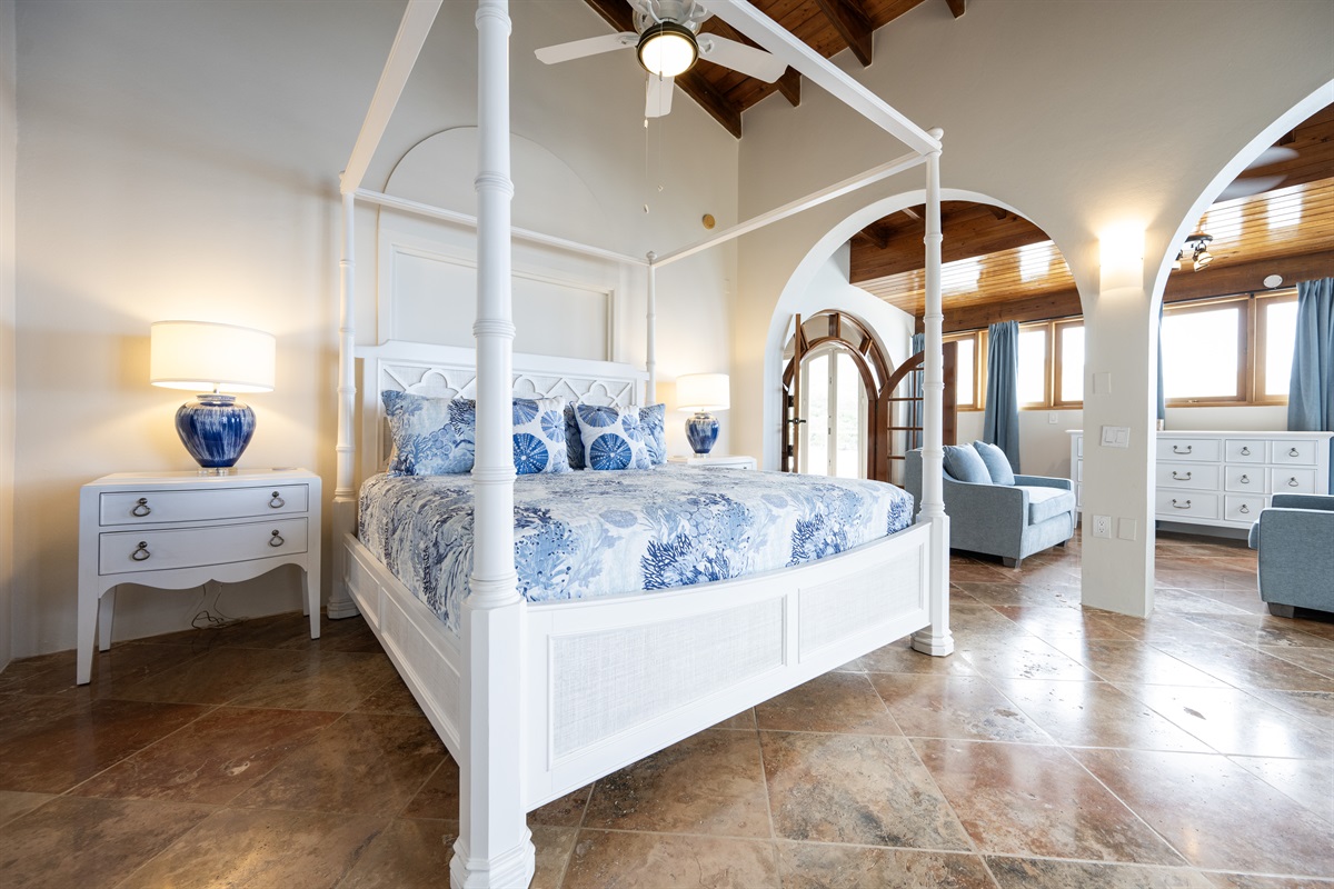 Main Floor Primary Bedroom: Elegant four-poster bed in the primary bedroom with two twin memory foam sleeper sofas.