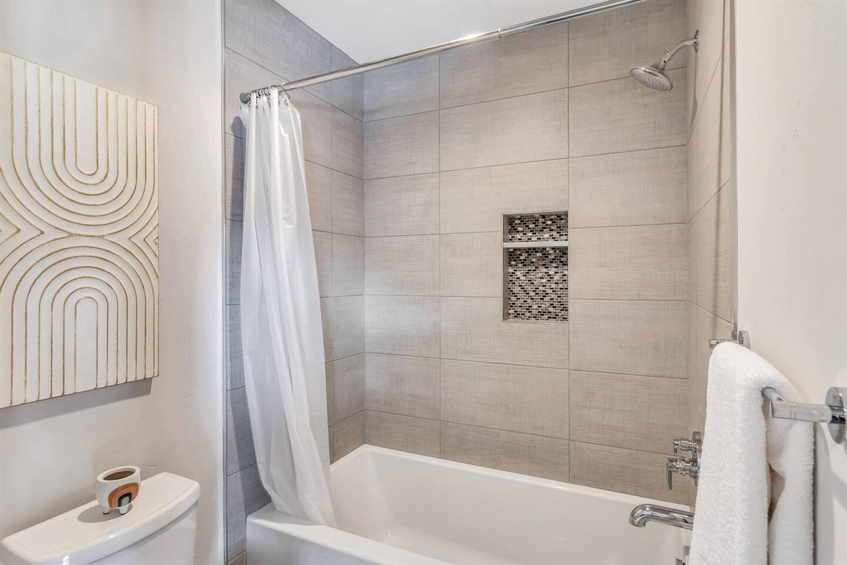 Secondary bathroom features a tub / shower combo