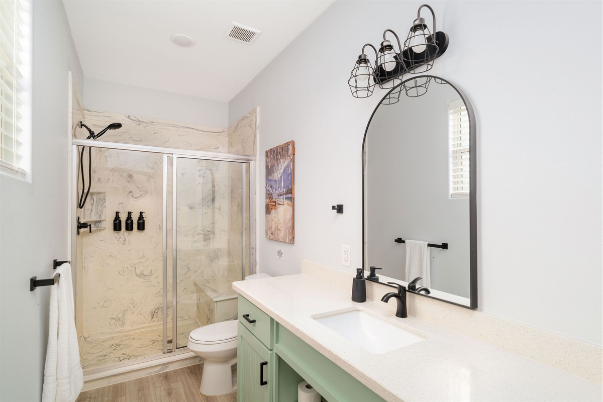 King Guest Suite ensuite — walk-in shower, green vanity.