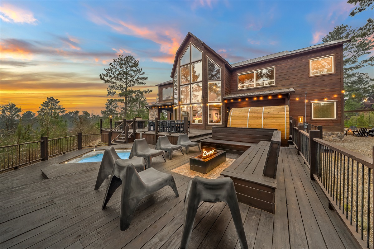 Golden hour on the deck - fire pit glowing, hot tub steaming, and the sauna warming up behind you. 