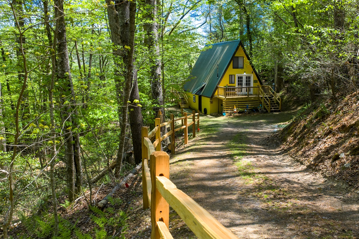 Bright, cheerful, and full of charm- Laurel Cove’s iconic yellow A-frame welcomes you to your own tucked-away retreat in the woods.