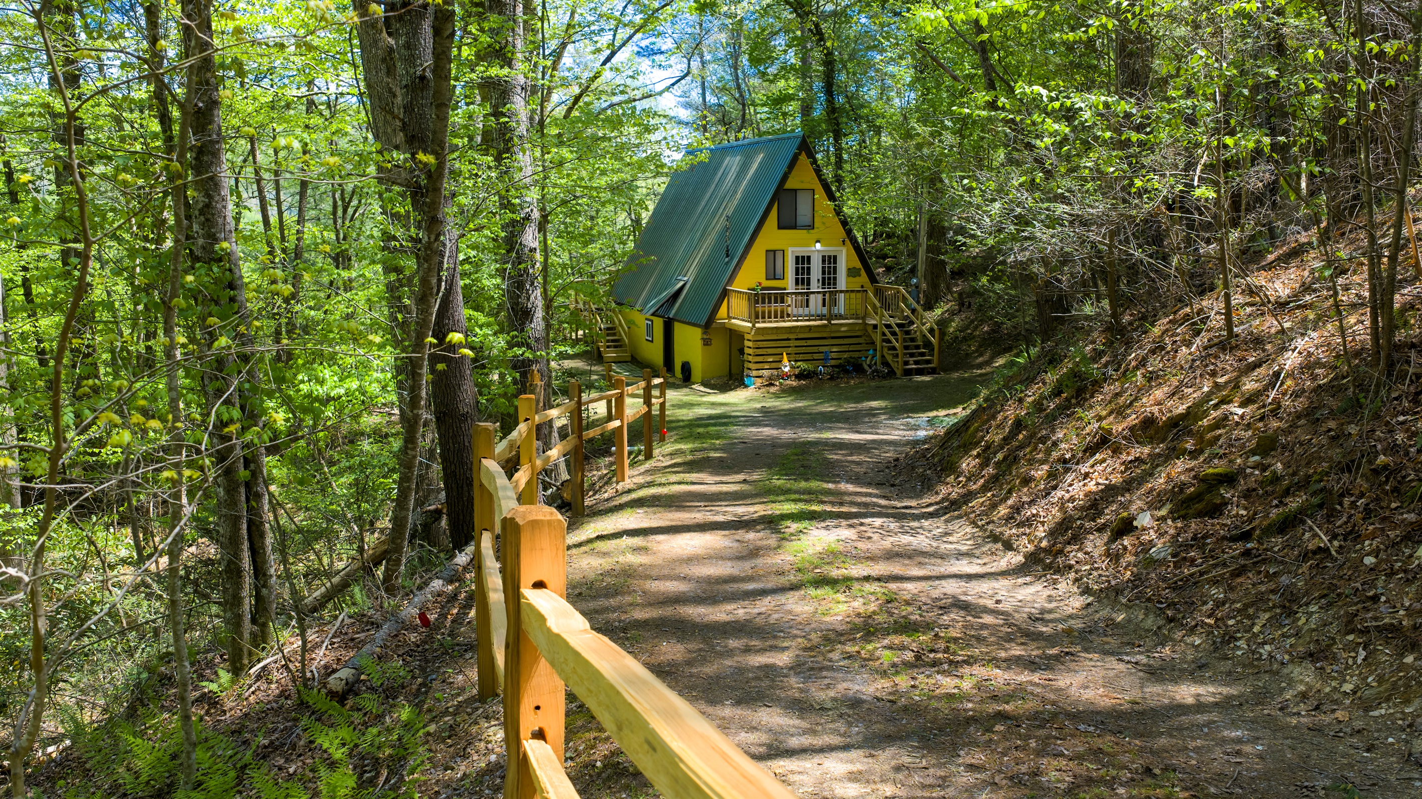 Bright, cheerful, and full of charm- Laurel Cove’s iconic yellow A-frame welcomes you to your own tucked-away retreat in the woods.