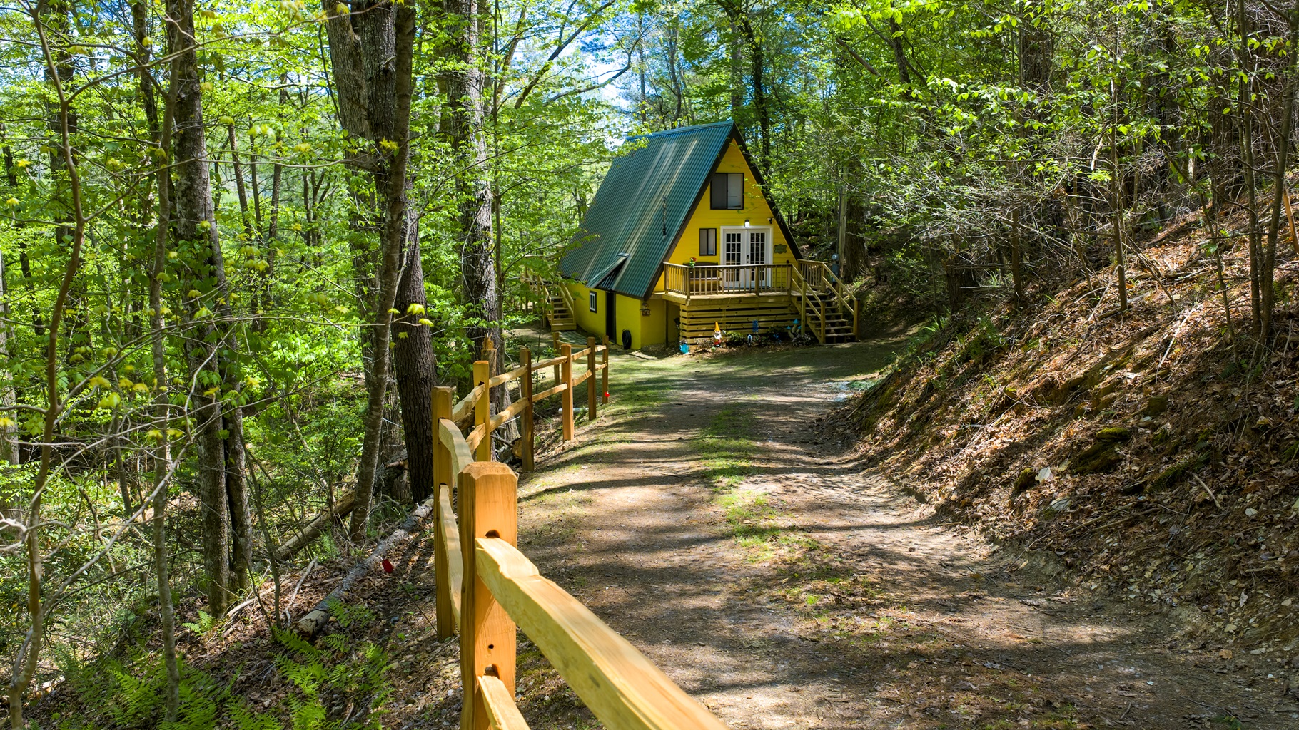 Bright, cheerful, and full of charm- Laurel Cove’s iconic yellow A-frame welcomes you to your own tucked-away retreat in the woods.