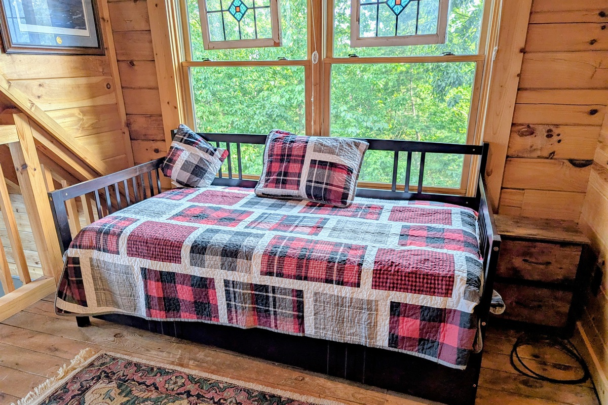 Twin bed with trundle located in the loft. 