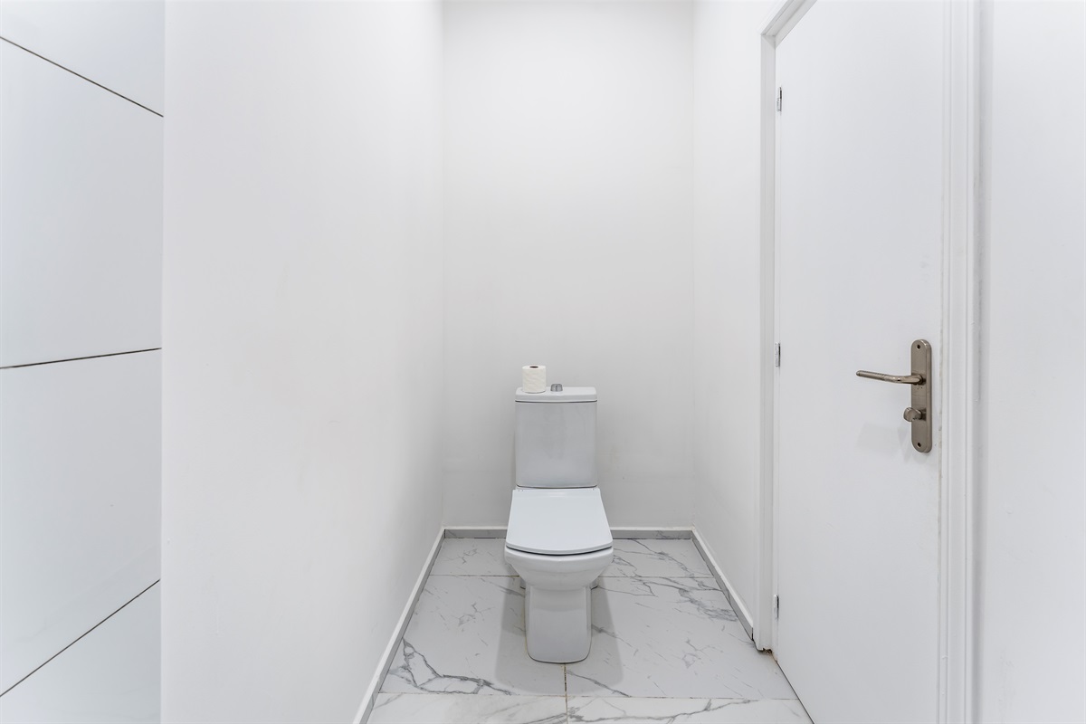 Half bath/powder room to the left of entrancce