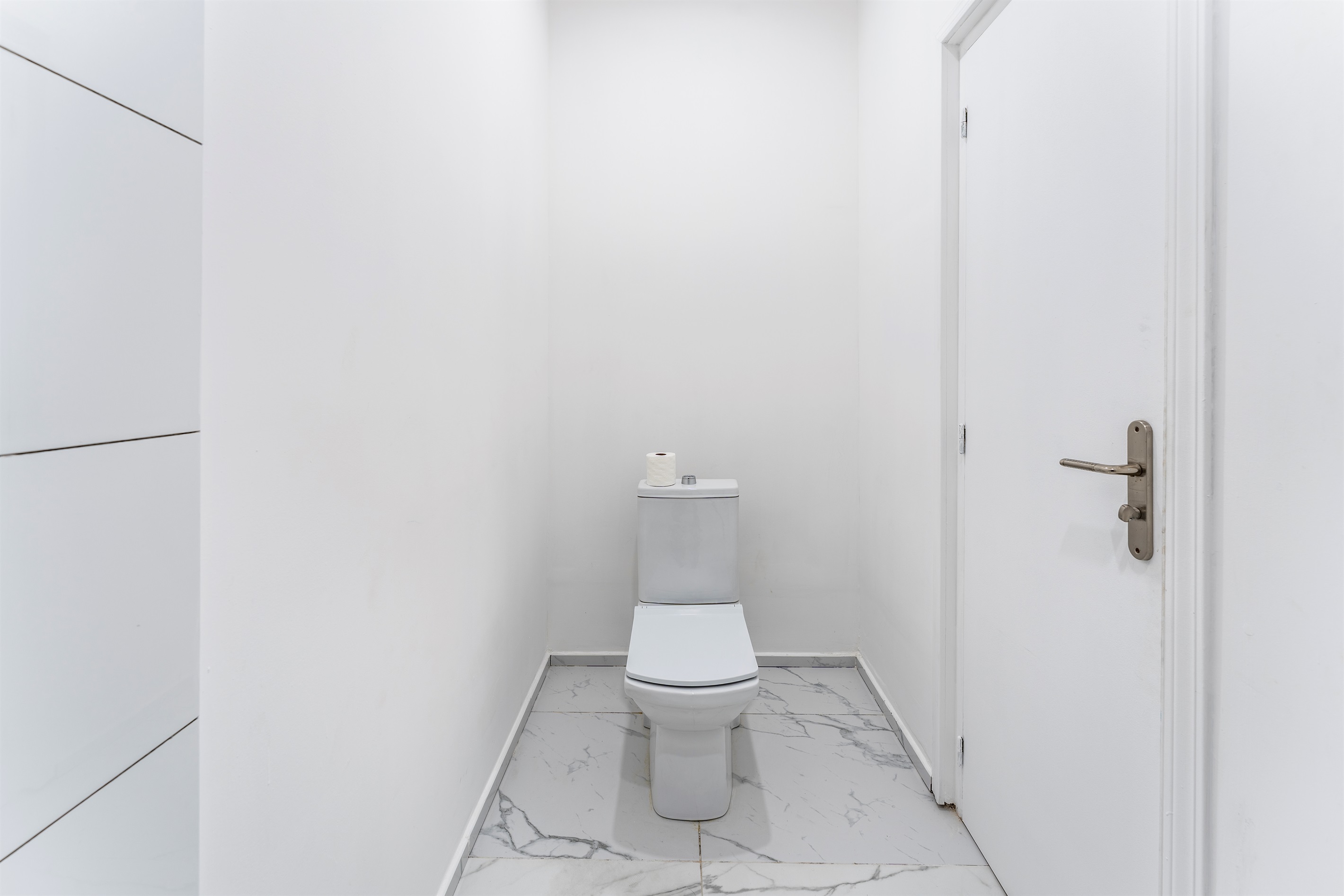 Half bath/powder room to the left of entrancce