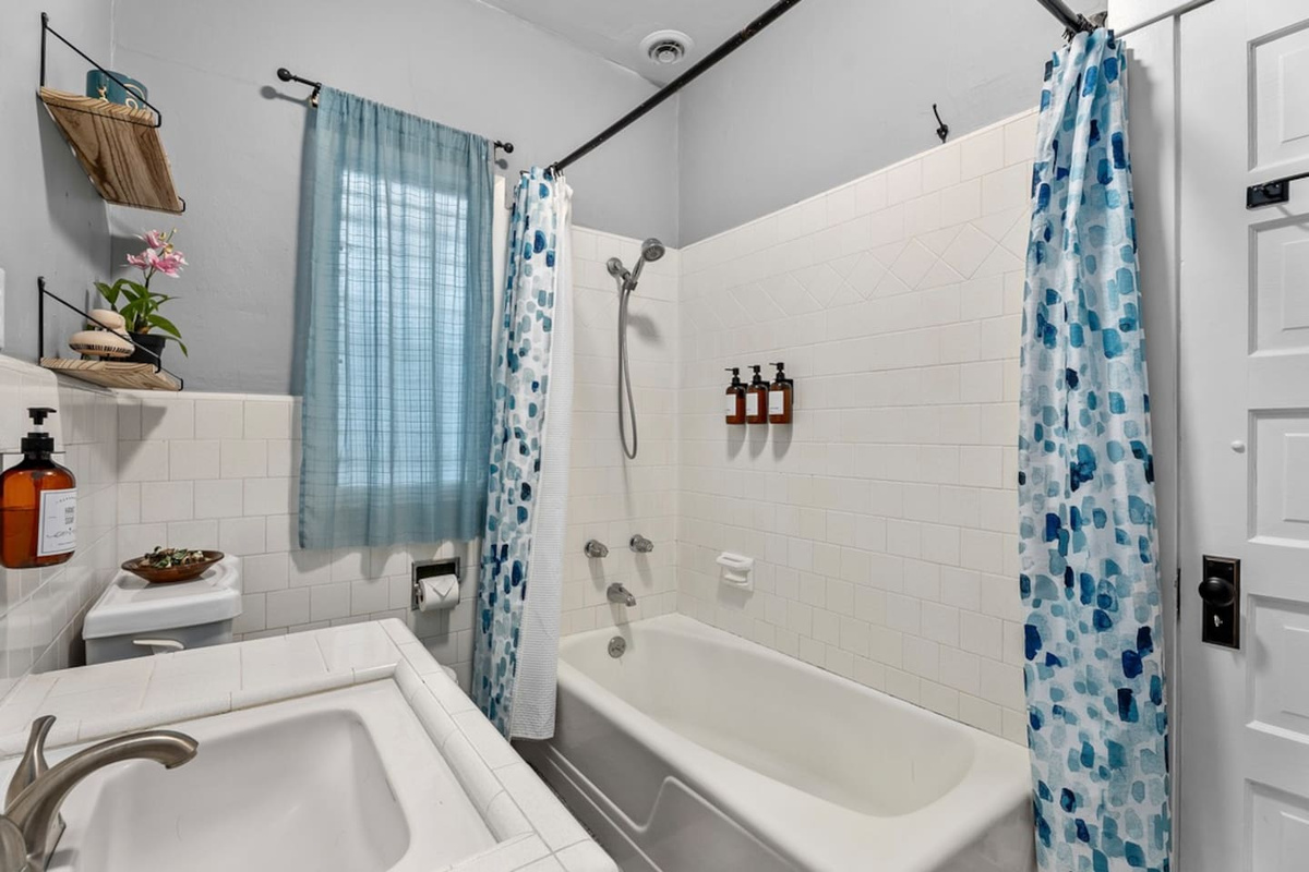 The full bathroom connects two bedrooms.