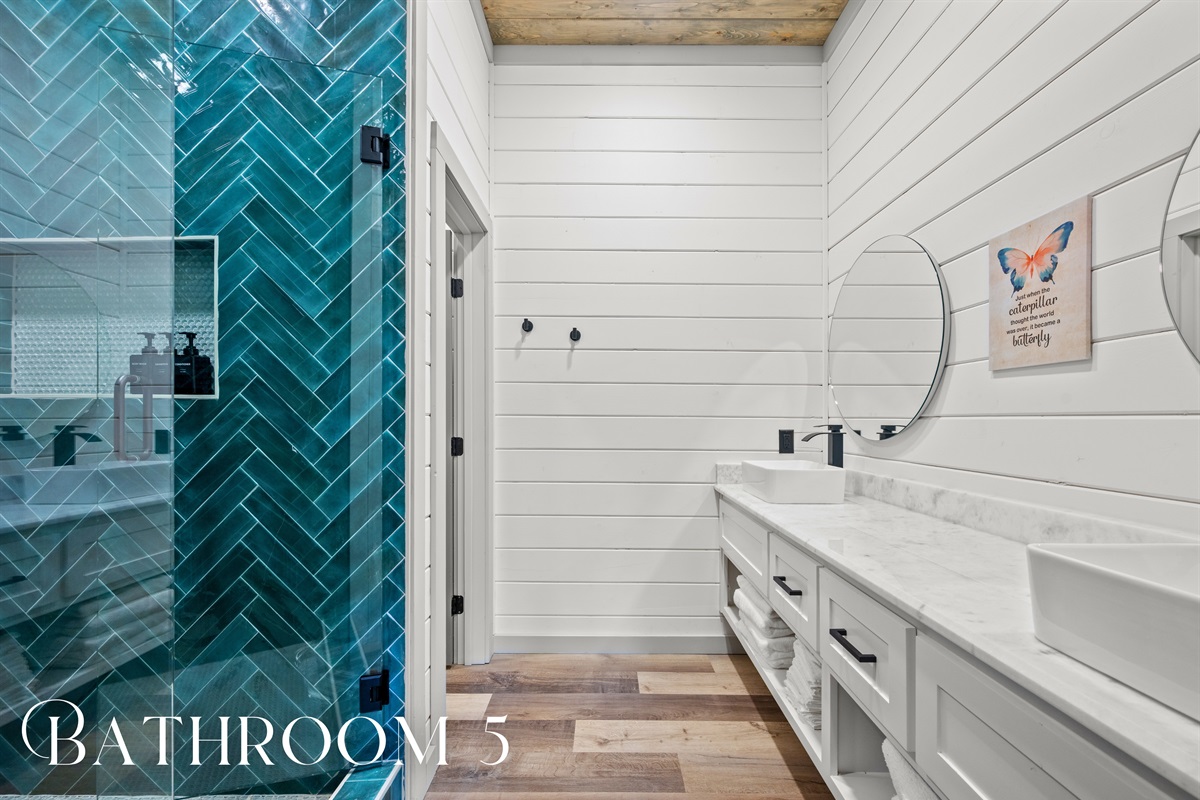 Modern lighting and clean finishes keep every bathroom in the cabin fresh, bright, and effortlessly stylish.