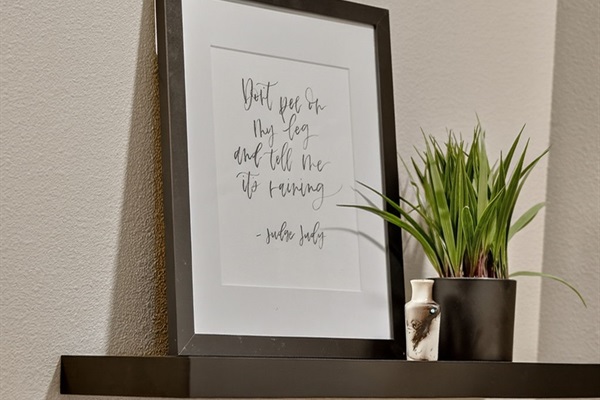 Minimalist artwork accents the bathroom space with color and design.