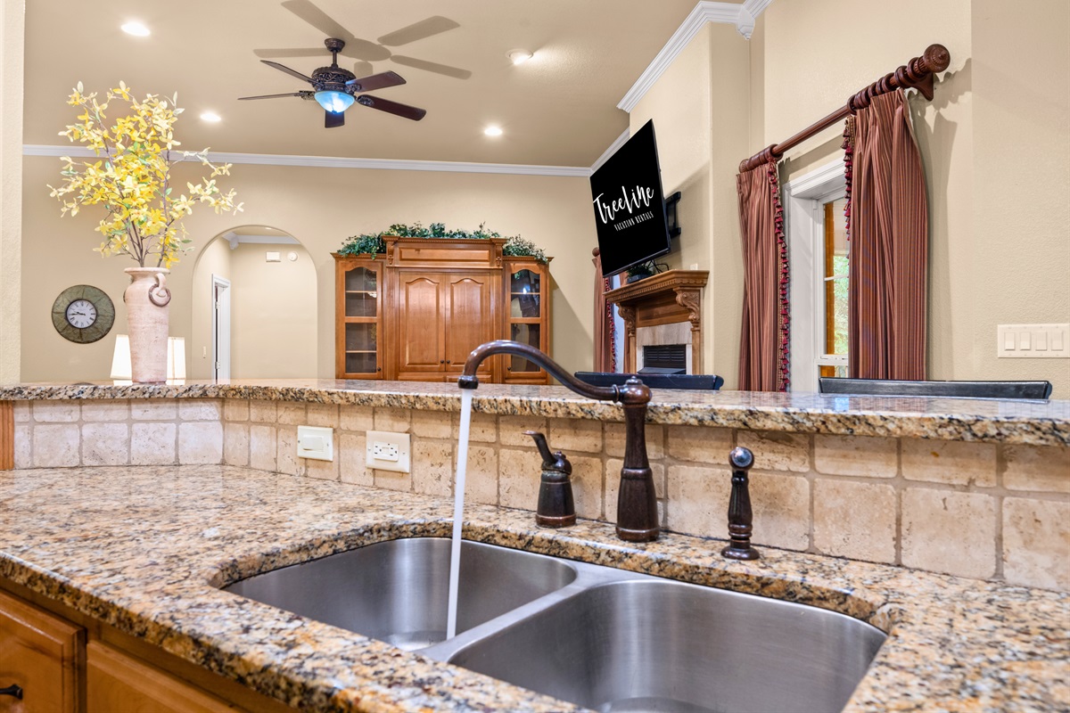 Large kitchen sink and view into living area.