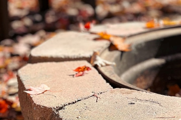 Cozy fire pit, with plastic chairs, perfect for relaxing evenings under the stars. Ample seating for everyone.

