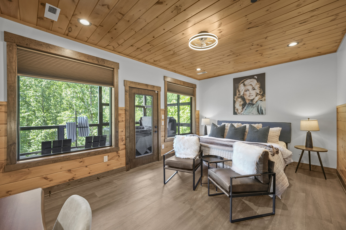 Relax in the spacious king bedroom on the game room level with a big TV, desk & direct deck hot tub access. Unwind in the en-suite bathroom featuring a walk-in shower with a natural river rock floor, bringing  the Smoky Mountains indoors for a spa retreat.