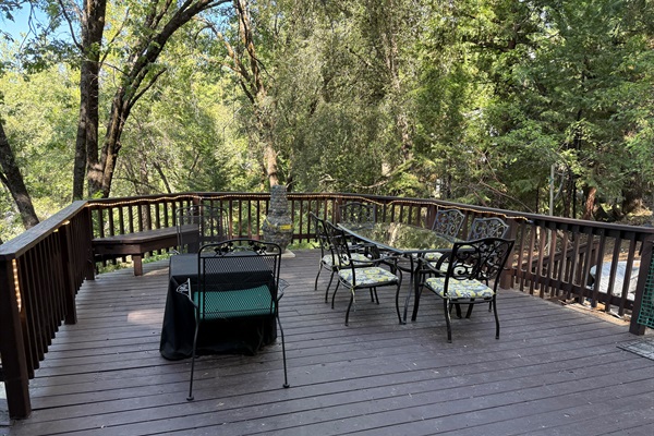 Large and peaceful deck surrounded by towering trees